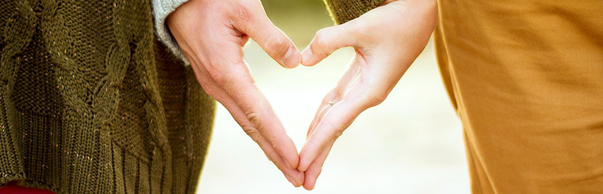 Couple Making A Heart With Their Hands